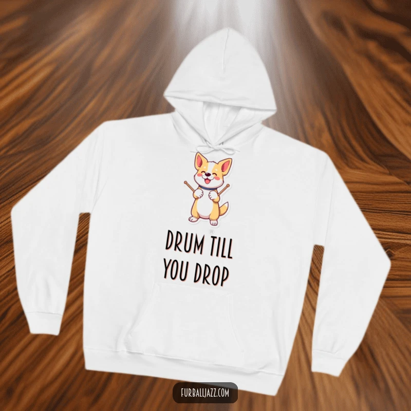 Funny dog energetically tapping drumsticks on a paw on a hoodie.