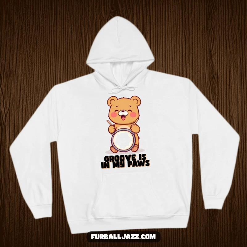 Funny bear character joyfully tapping drumsticks on a snare drum, embodying musical energy on a warm, funny hoodie.